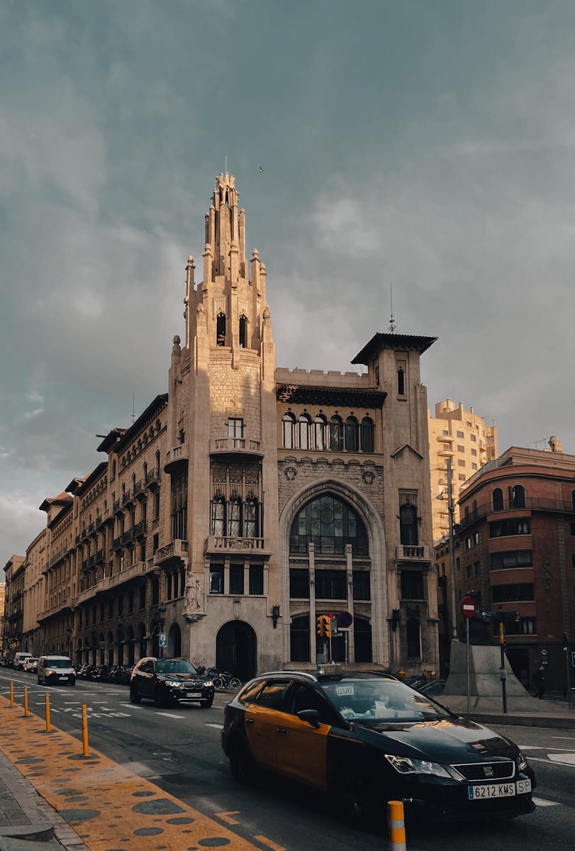 A stunning Gothic-style building on Via Laietana, Barcelona with bustling street life.