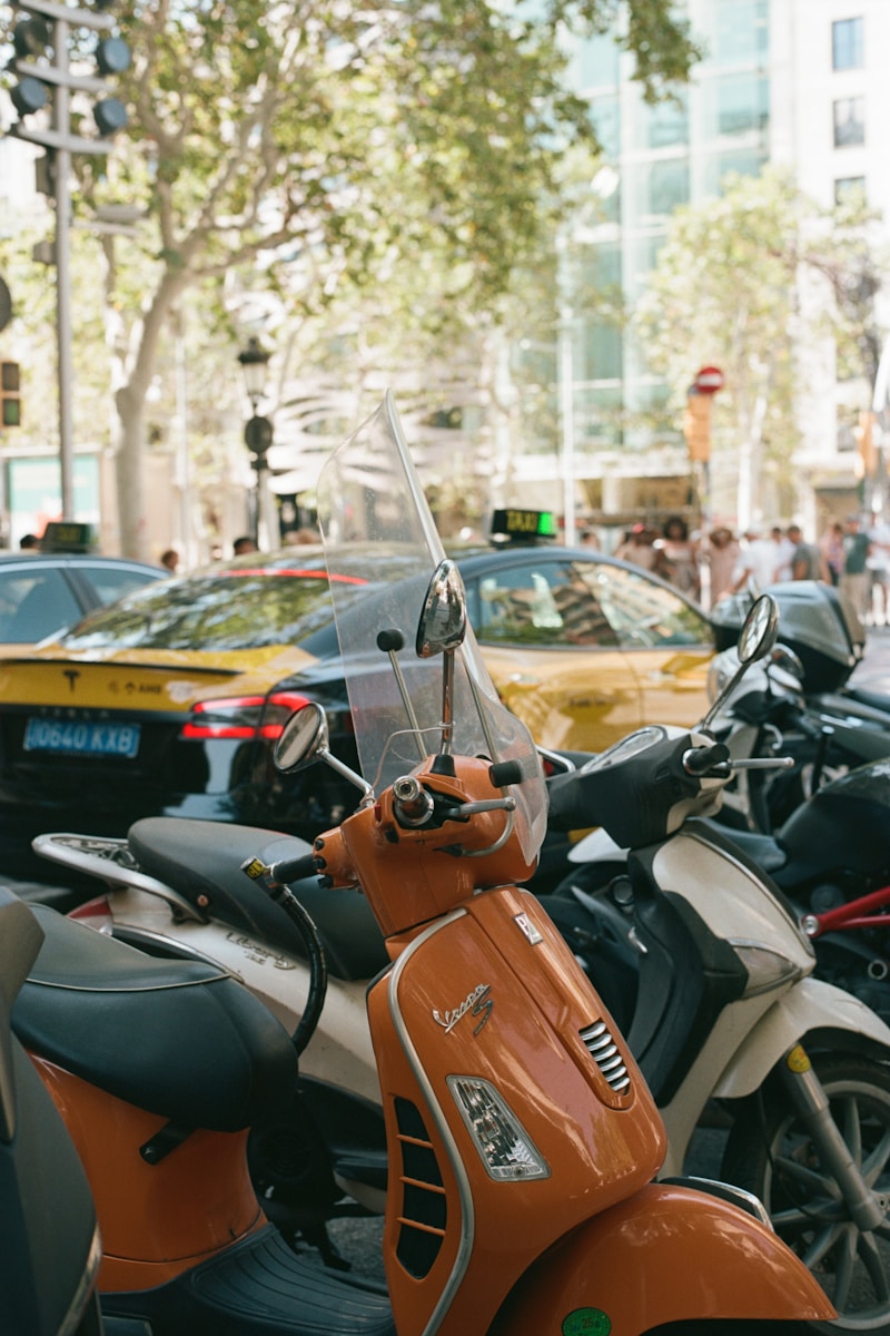 A row of scooters parked on the side of a street