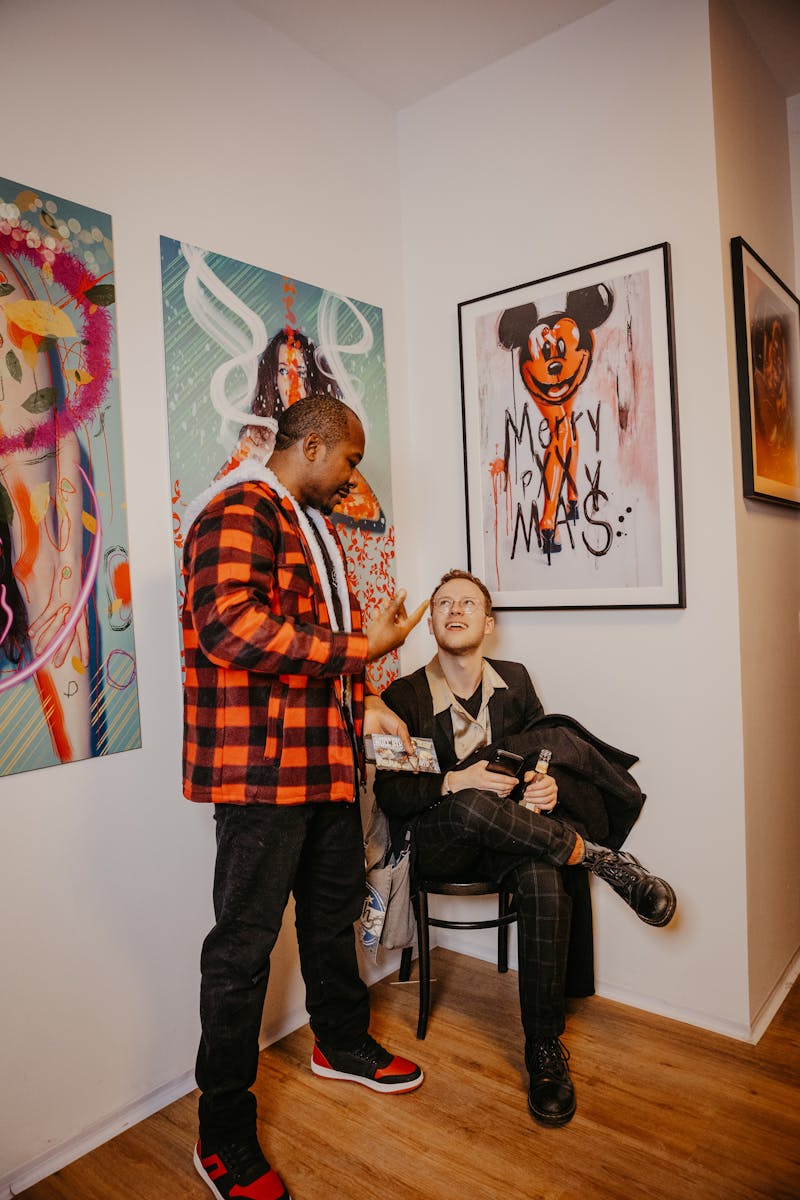 Lively art gallery event in Berlin featuring colorful graffiti-style artworks and a diverse crowd.