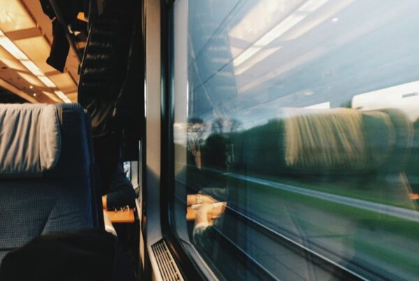 A serene view from inside a modern train, capturing the motion and landscape outside.