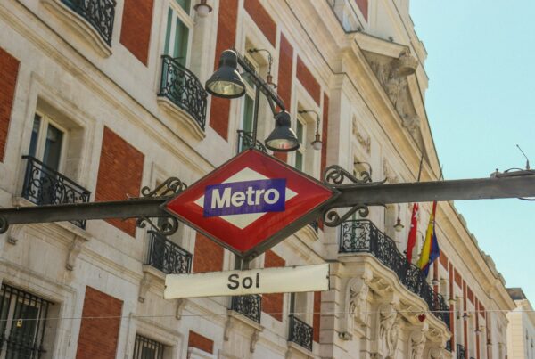a metro sign hanging off the side of a building
