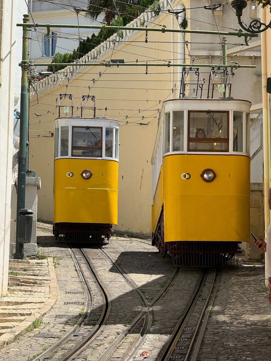 A couple of yellow trains traveling down train tracks
