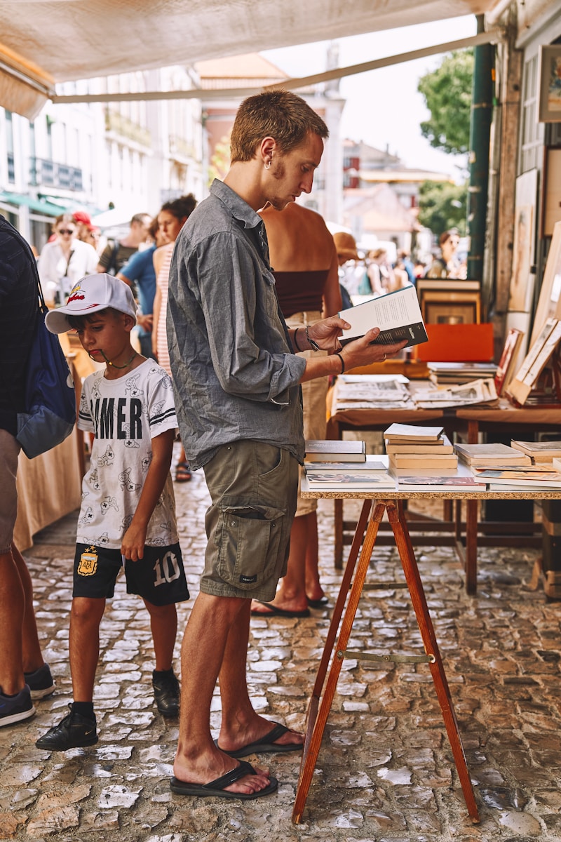 a man standing next to a little boy