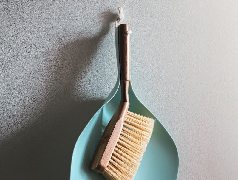 brown wooden brush on white wall